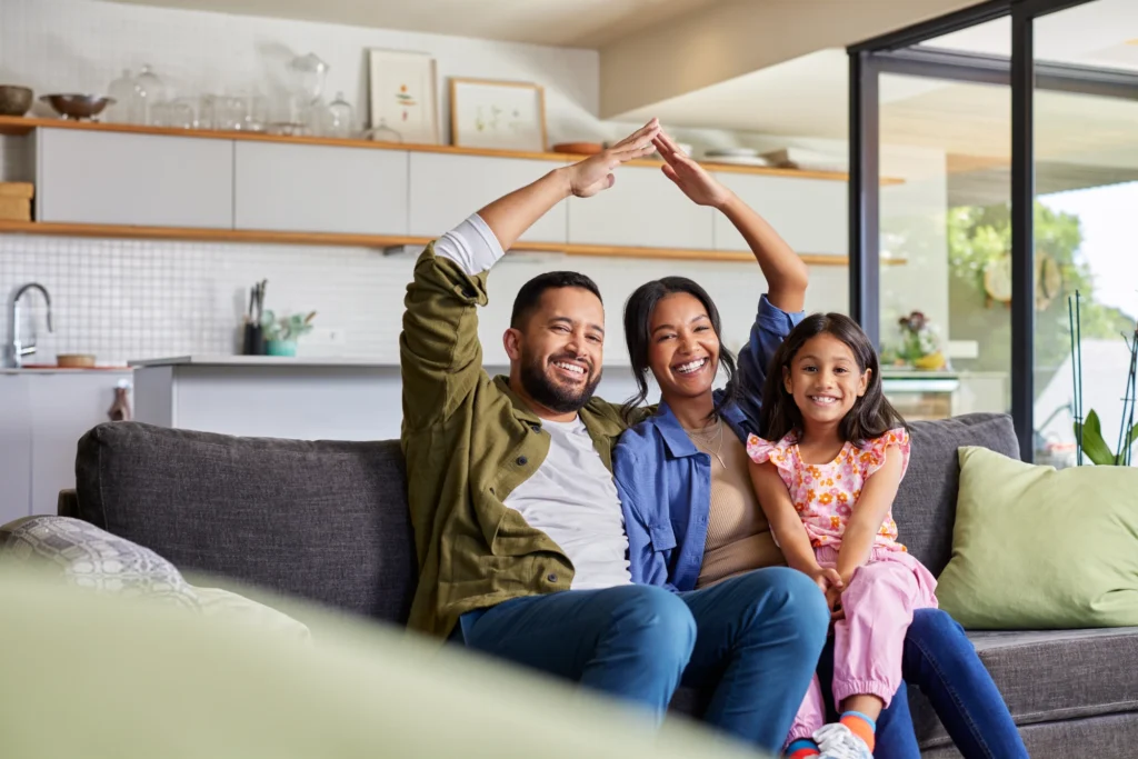 Happy family sitting on a couch together.