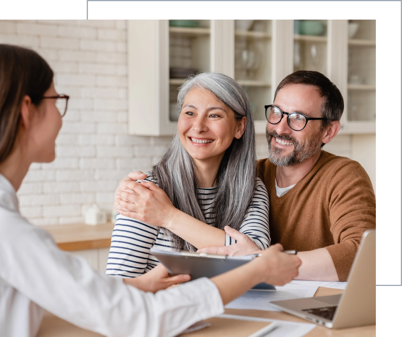 Couple smiling during meeting with consultant.